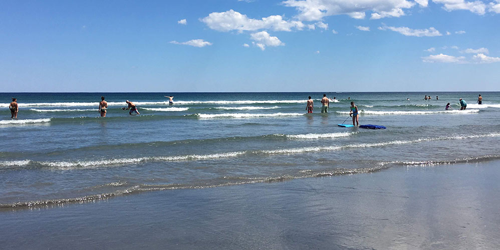 People enjoying the water at Long Sands Beach